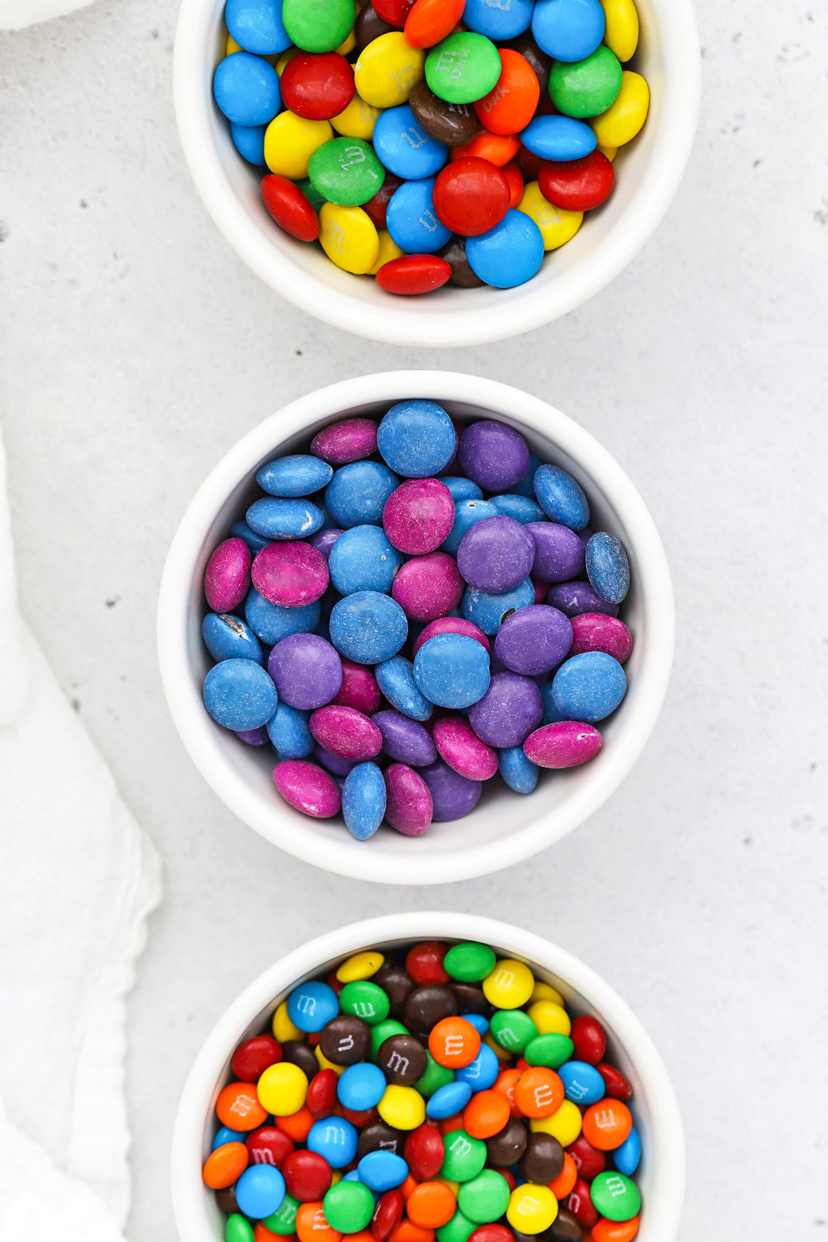 Overhead view of m&ms, unREAL vegan m&m candies, and mini m&ms