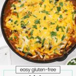 Chicken enchilada skillet with bubbling sauce and melty cheese