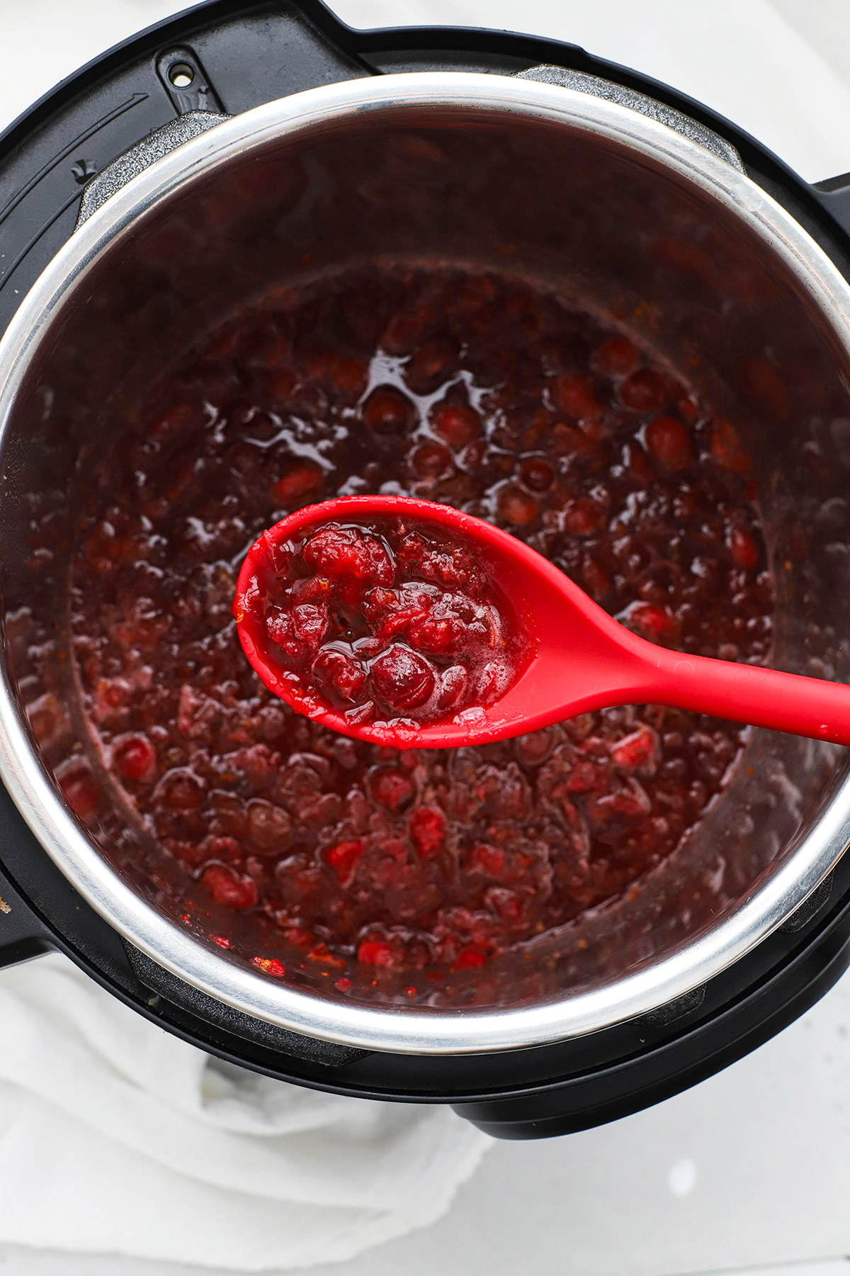 overhead view of a spoon scooping up instant pot cranberry sauce
