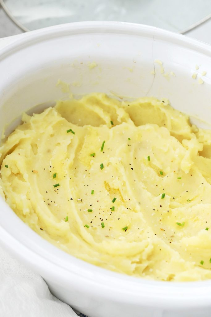 Front view of a crock of slow cooker mashed potatoes