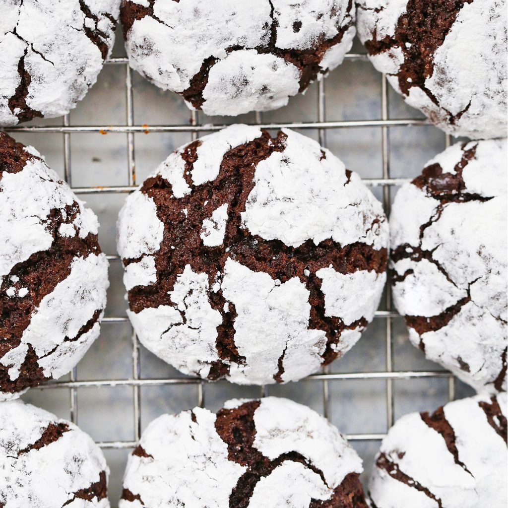 gluten free chocolate crinkle cookies on a wire rack