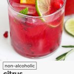 Bright red pomegranate mocktail in a small glass