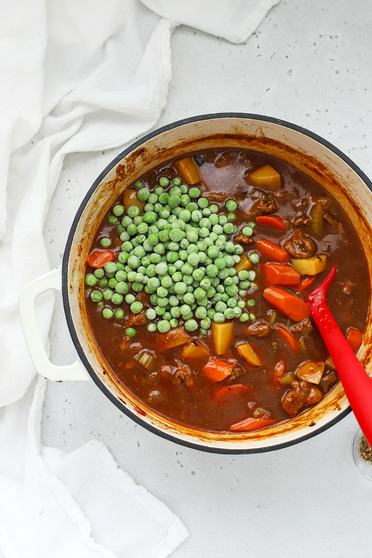 Adding frozen peas to a Dutch oven of beef stew