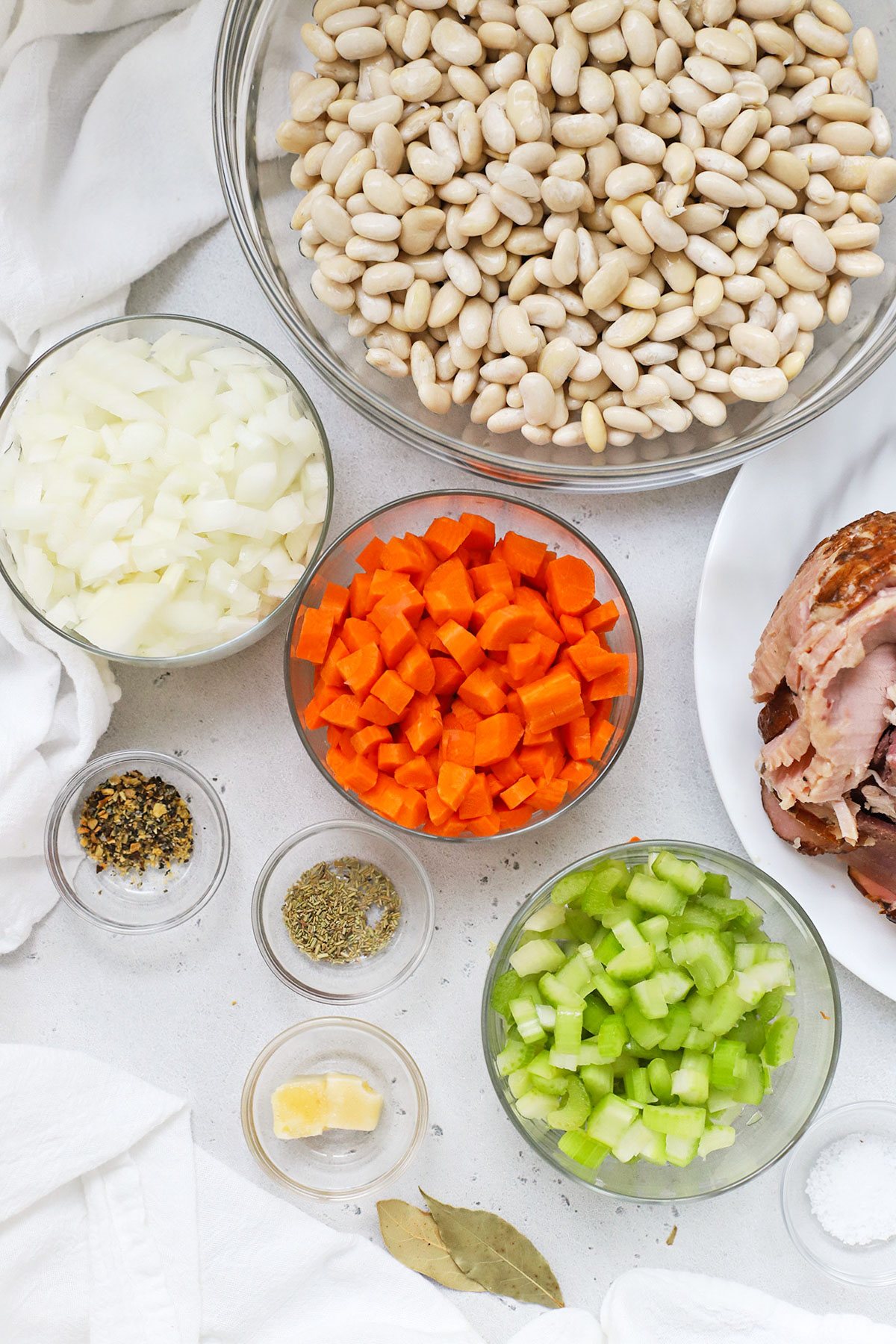 ingredients for crock pot ham and bean soup in small bowls