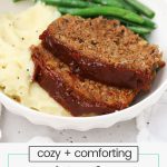 Two slices of gluten-free meatloaf with fluffy mashed potatoes and steamed green beans