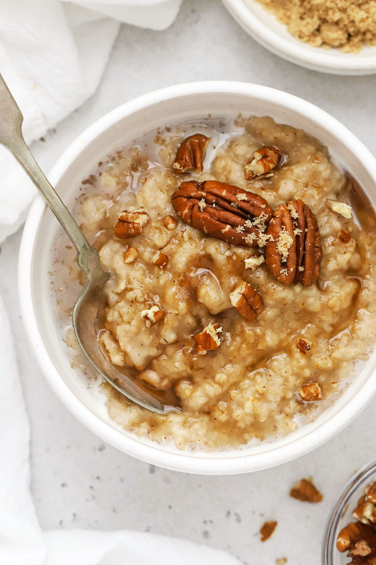 homemade maple brown sugar oatmeal with pecans in a white bowl