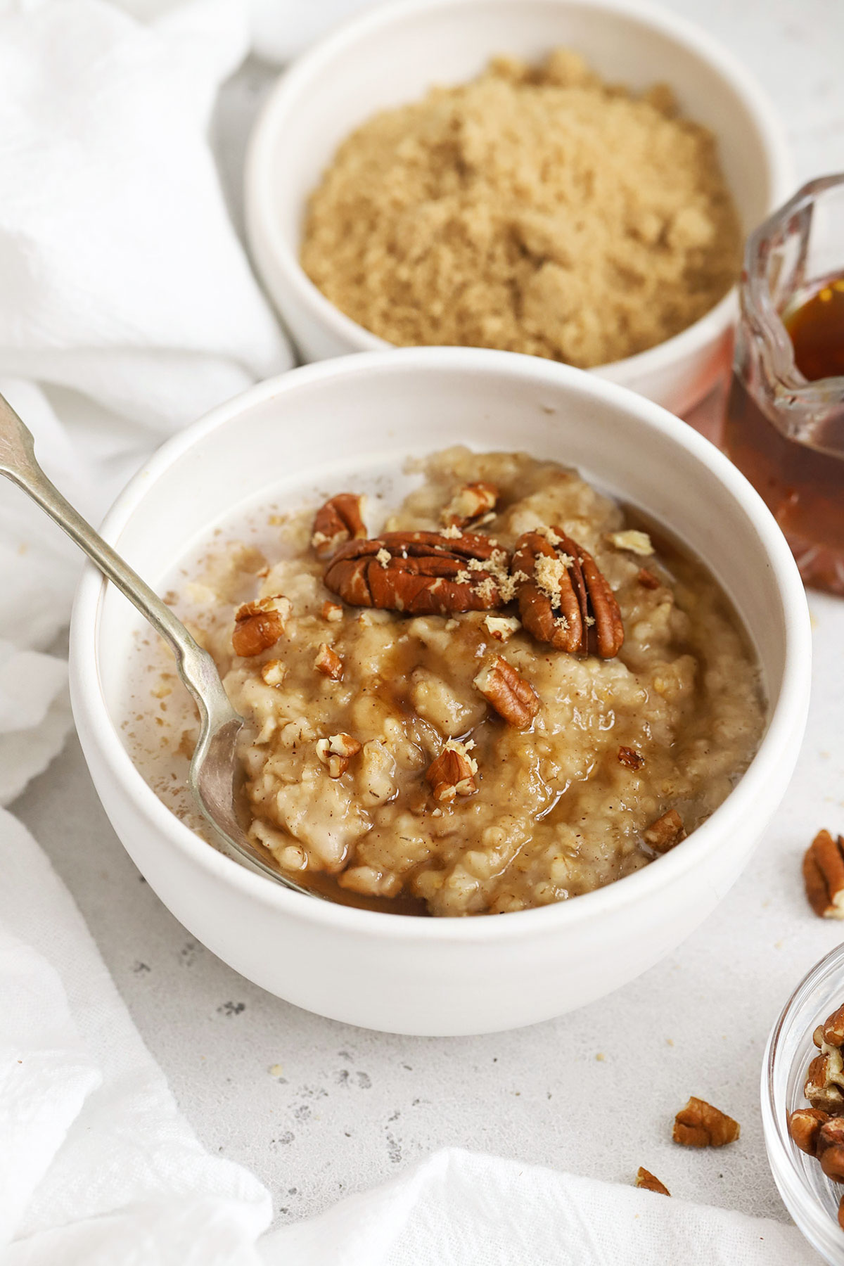 front view of maple brown sugar oatmeal with pecans in a white bowl