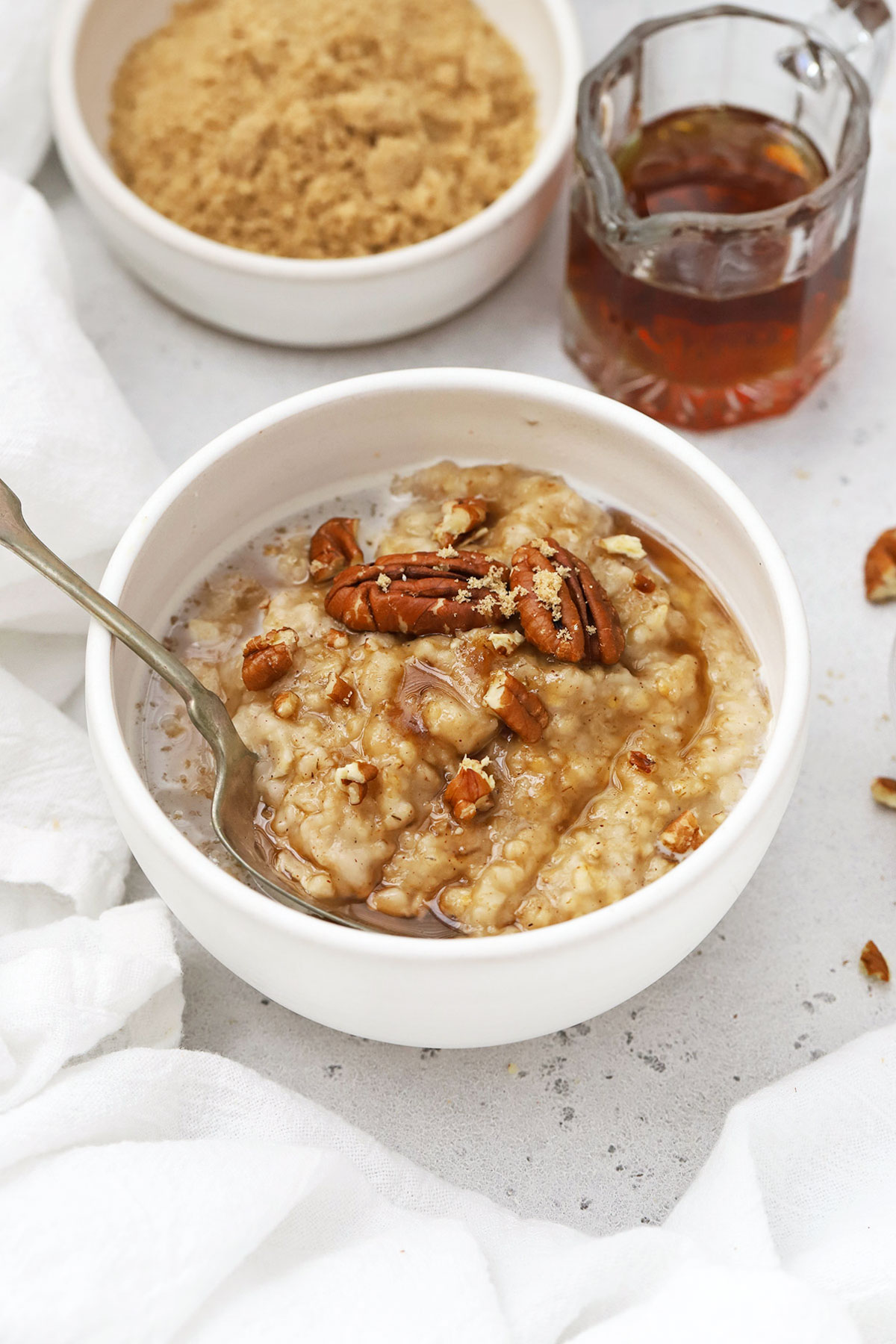 front view of maple brown sugar oatmeal with pecans in a white bowl
