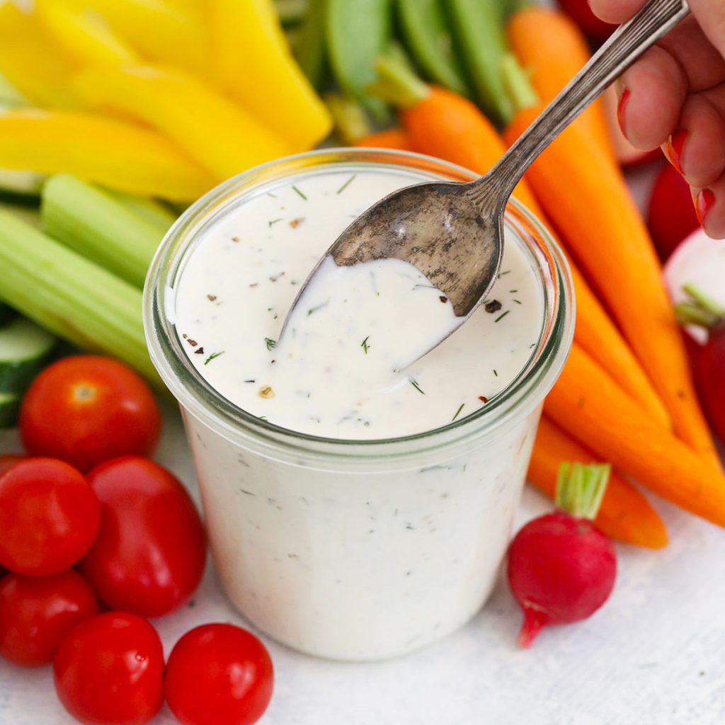 paleo ranch dressing surrounded by colorful vegetables