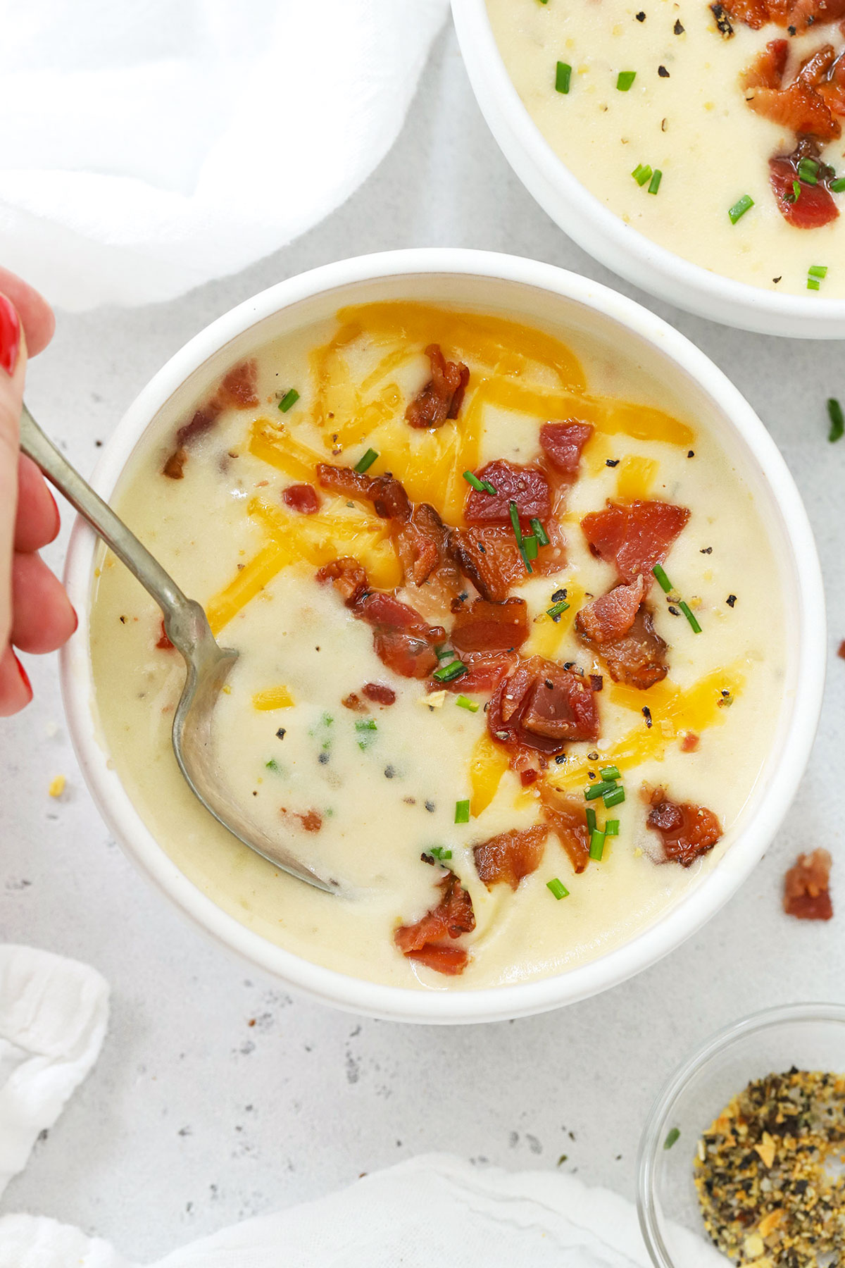 Spooning up a bite of gluten-free potato soup
