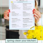 woman holding a kitchen cleaning checklist