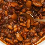crock pot baked beans in a white crock