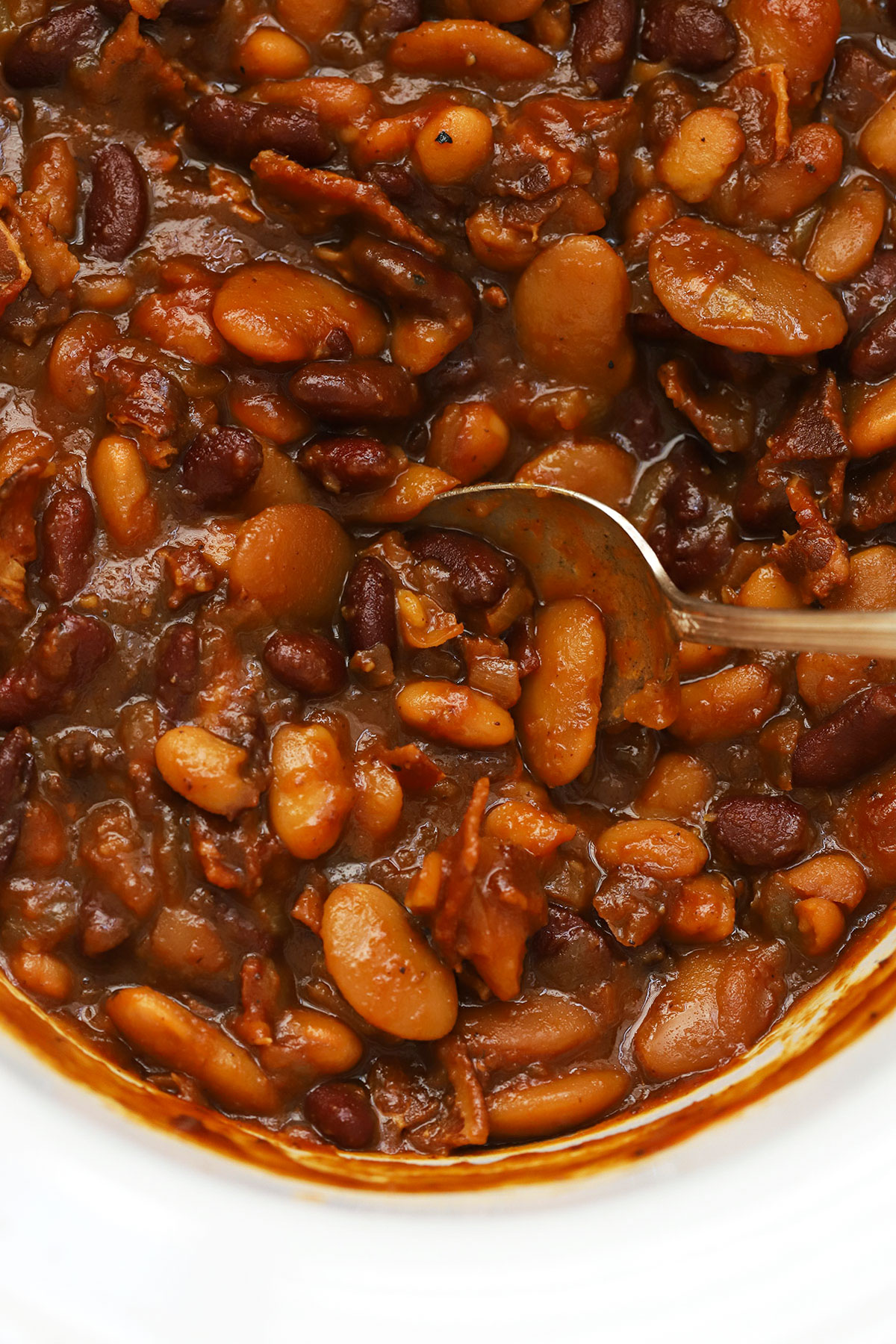 crock pot baked beans in a white crock
