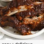 crock pot ribs on a white platter with barbecue sauce