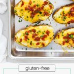 Twice baked potatoes with bacon and cheese on a baking sheet