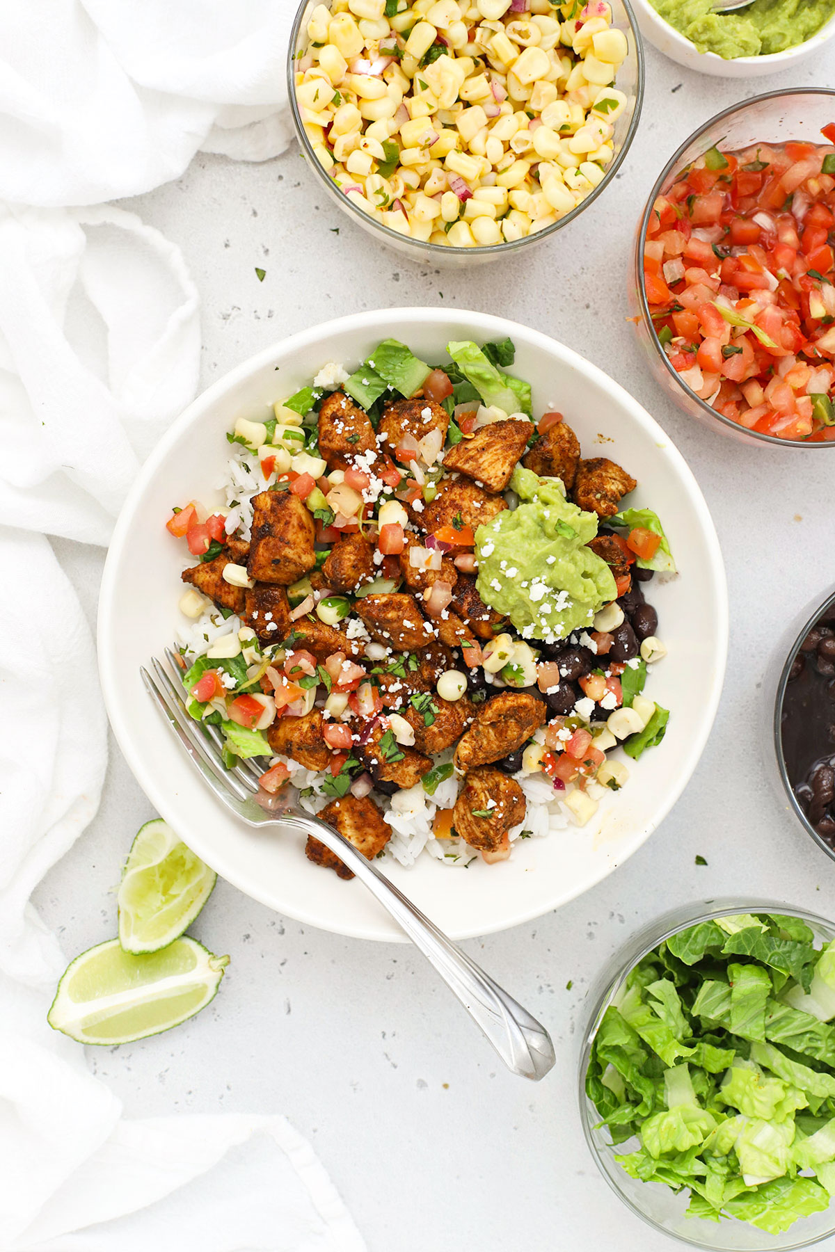 gluten-free chicken burrito bowl with rice, beans, salsa, and guacamole