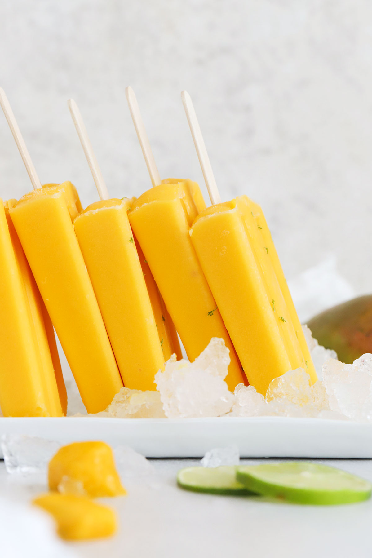 mango popsicles on a plate of ice