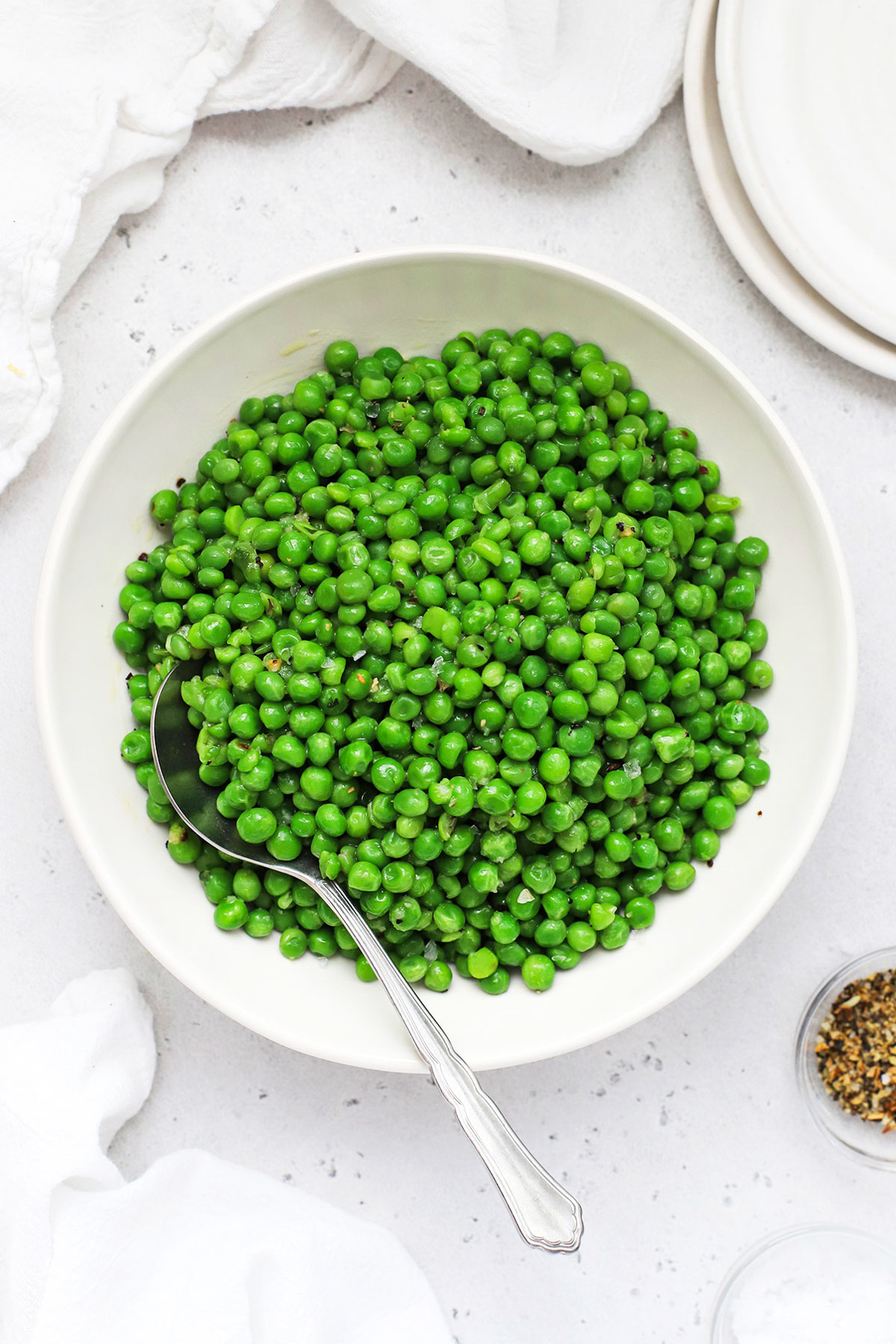 cooked frozen peas in a white bowl