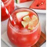 watermelon mocktails garnished with lime flower and red and white striped straw