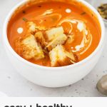 gluten-free tomato soup in white bowls with grilled cheese croutons