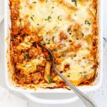Overhead view of cheesy gluten-free baked ziti in a white baking dish