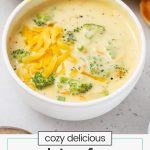 bowls of gluten-free broccoli cheddar soup with slices of gluten-free baguette