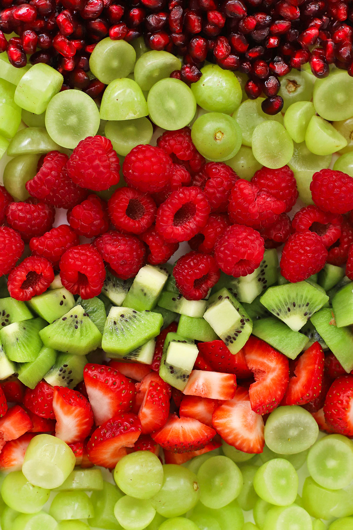 red and green fruits lined up to make holiday fruit salad