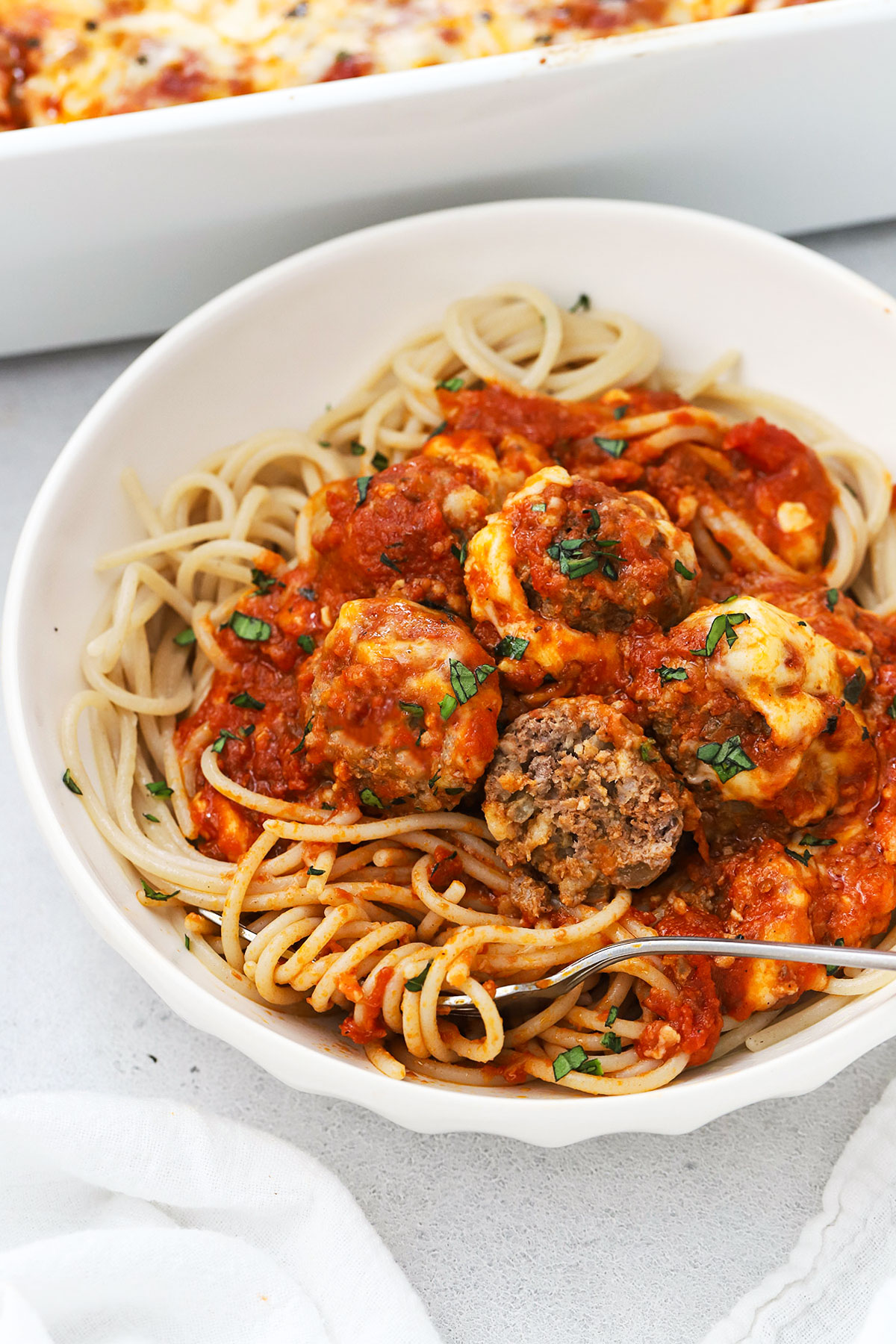 gluten-free spaghetti and meatballs on a white plate
