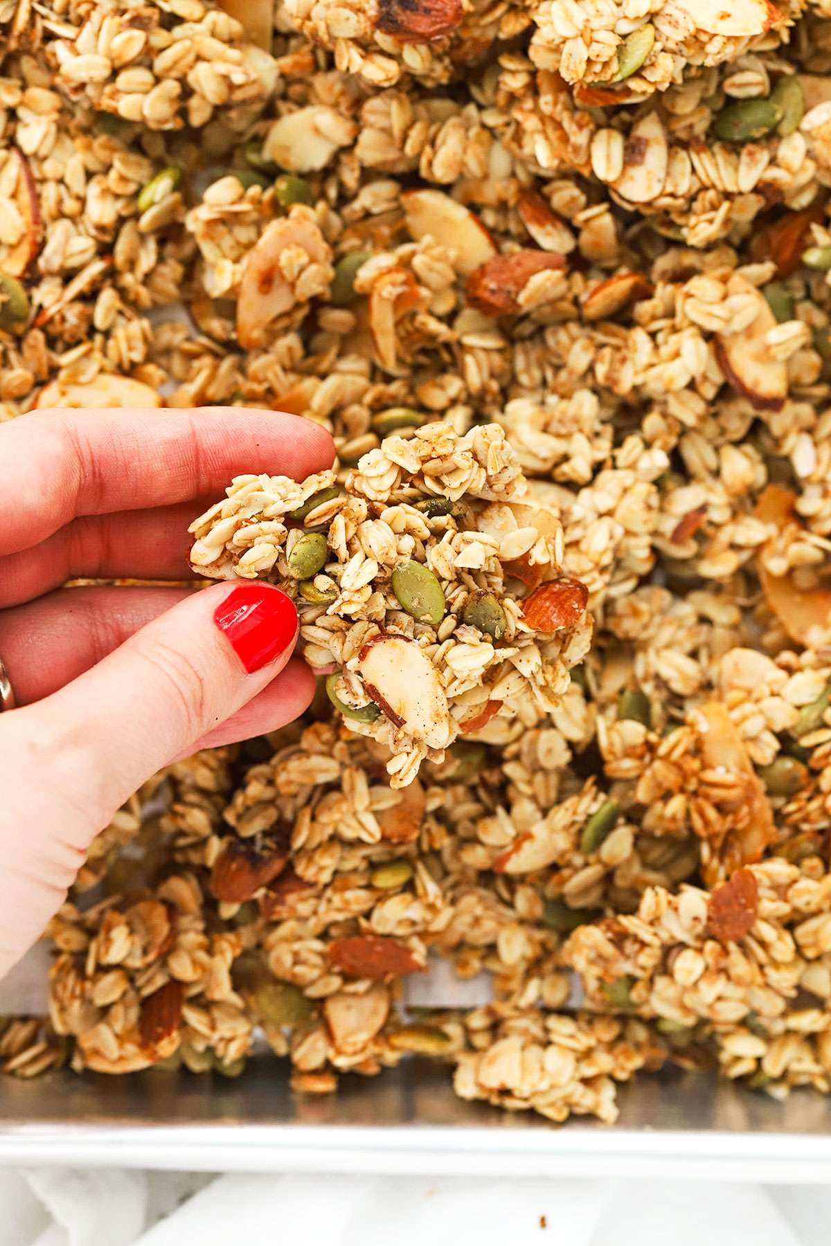 holding up a large gluten-free granola cluster