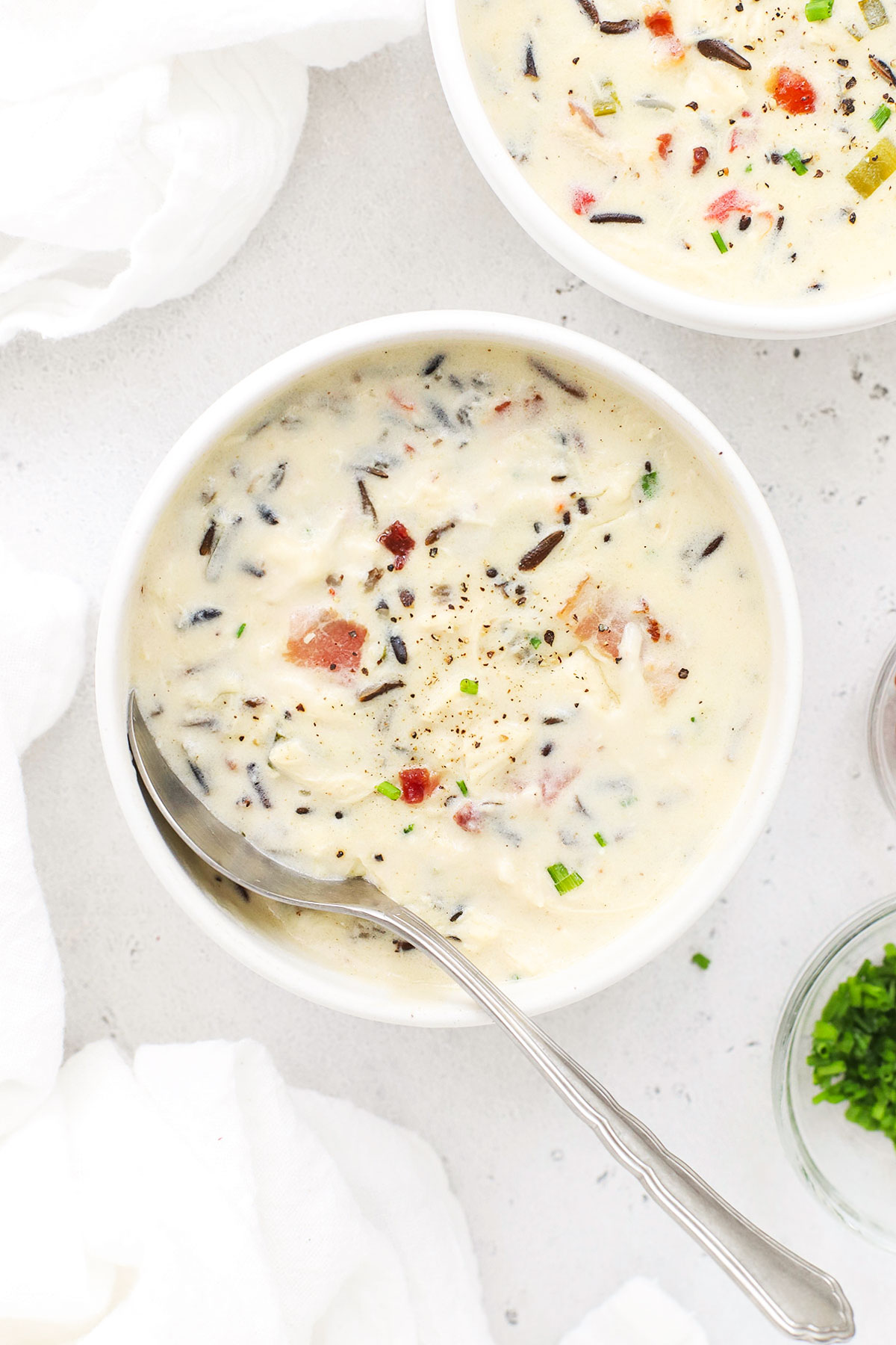 two bowls of gluten-free chicken wild rice soup with bacon