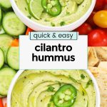 two bowls of cilantro hummus with fresh veggies and pita chips