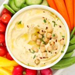 hummus surrounded by colorful vegetables
