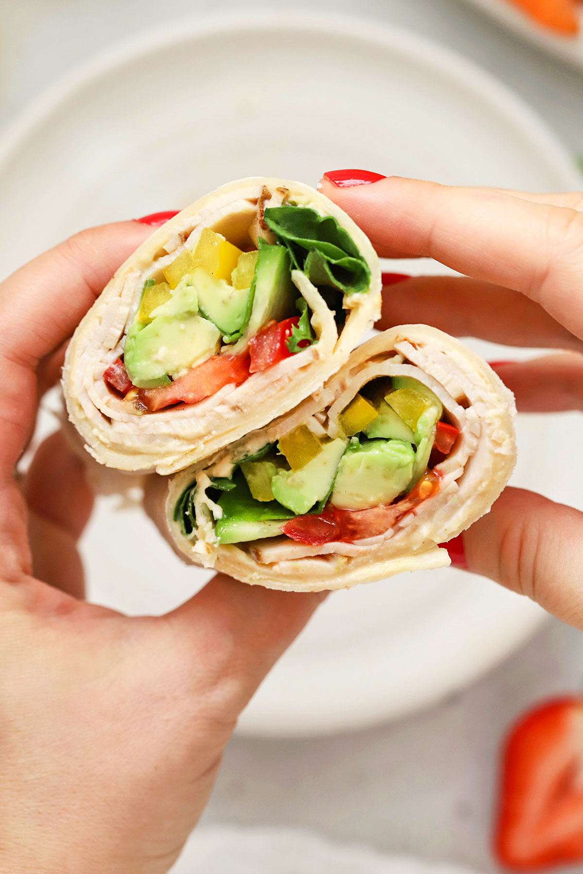 Gluten-free turkey wrap with hummus, avocado, and fresh veggies