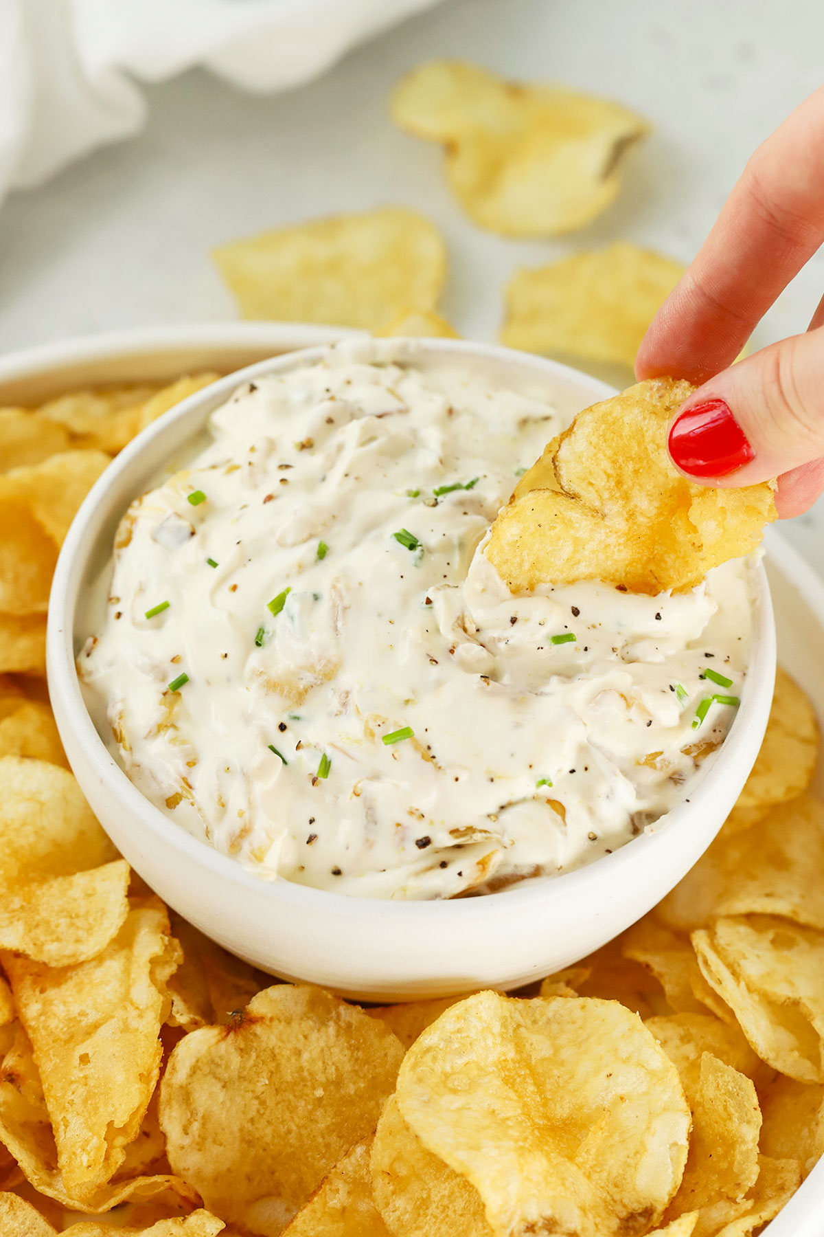 dipping chips into healthy onion dip
