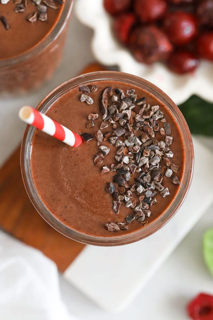 chocolate cherry smoothie topped with cacao nibs