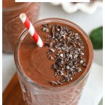 chocolate cherry smoothie in an embossed glass with a red and white striped straw