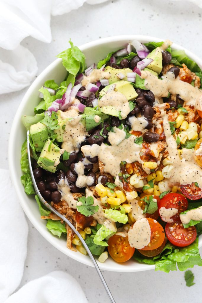 BBQ chicken salad with black beans, corn, tomatoes, avocado, red onion, and cilantro