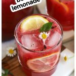 honey berry lemonade topped with fresh mint, lemon slices, and chamomile blossoms