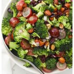 a bowl of vegan broccoli salad with poppy seed dressing