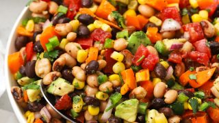 colorful cowboy caviar salad in a white serving bowl