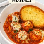 Gluten-free chicken parmesan meatballs in marinara with a slice of gluten-free garlic bread