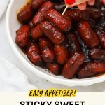 Picking up BBQ Lil Smokies from a bowl with a toothpick
