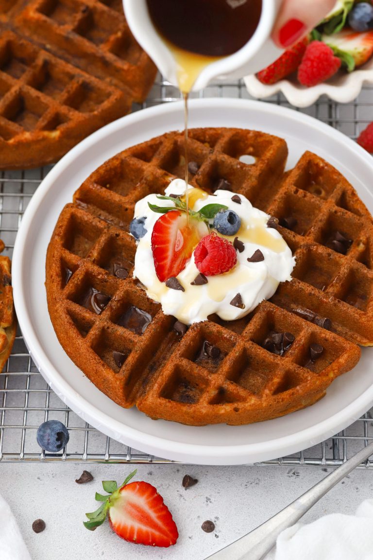 Pouring syrup over gluten-free chocolate chip waffles