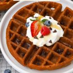 Pouring syrup over gluten-free chocolate chip waffles