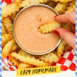 Dipping a french fry in a bowl of fry sauce