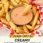 Dipping a french fry in a bowl of fry sauce