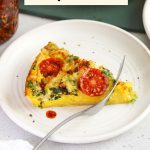 Fork cutting into a slice of tomato basil tortilla quiche