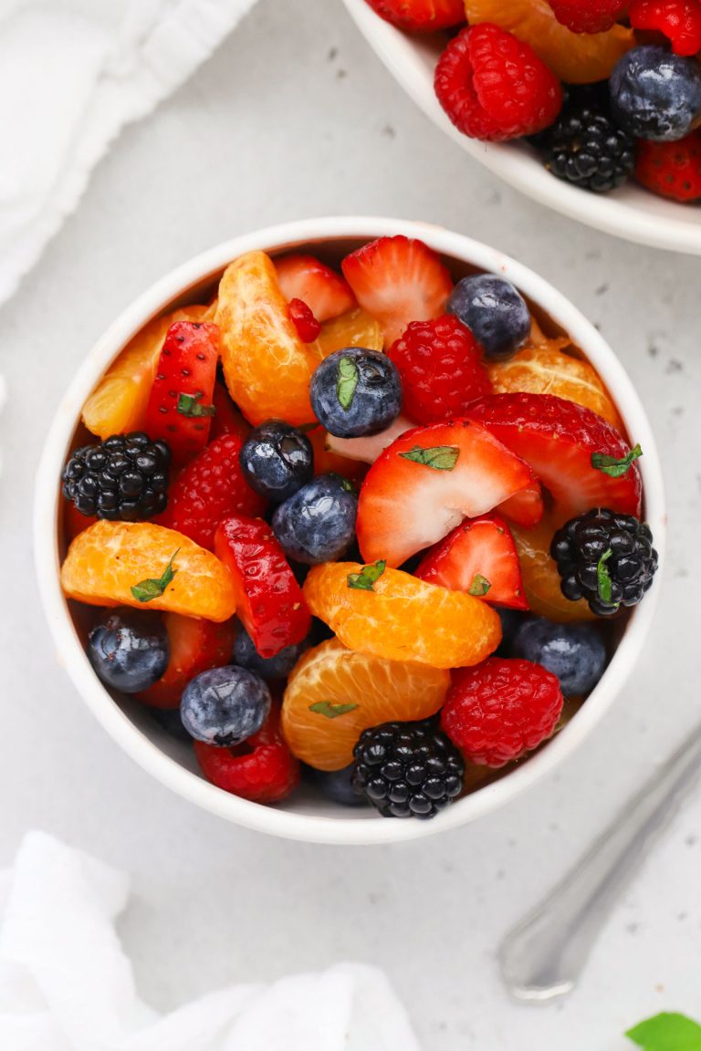 Bowls of fruit salad with oranges and fresh berries