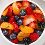Bowls of fruit salad with oranges and fresh berries