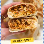 Holding a gluten-free ground chicken burrito cut in half